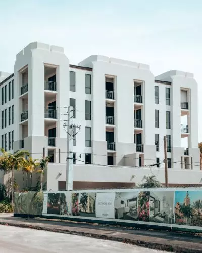 multi-story building with a painted white facade and balconies